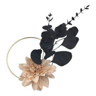 Floral headband with beige flower and black leaves on a white background