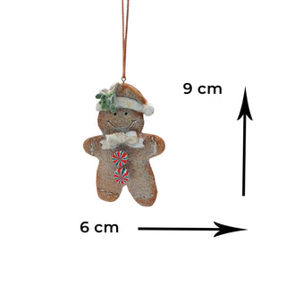 Decorative gingerbread man ornament with measurements on a white background