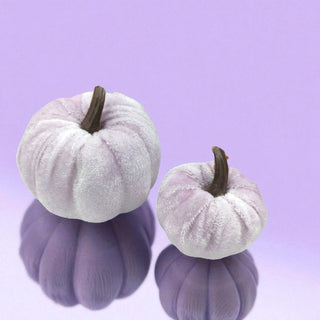 Two lavender pumpkins with brown stems on a light purple background