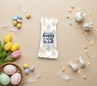 Easter-themed product packaging with decorative Easter eggs, bunnies, and flowers on a wooden surface.