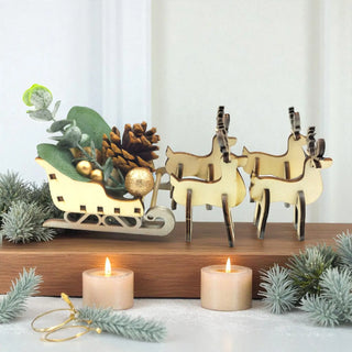 Decorative setup with reindeer, sleigh, and candles on a white background