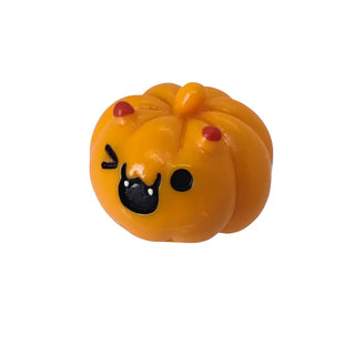 Pumpkin-shaped toy with a face on a white background