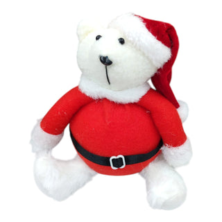 White teddy bear wearing a red Santa outfit with a white background