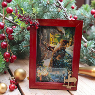 Decorative Christmas scene with a red frame, Christmas tree, and ornaments.