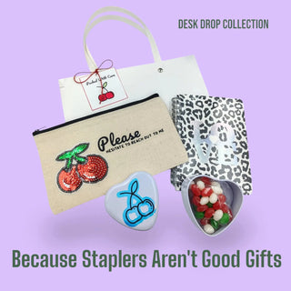 Desk drop collection with pouch, stationery items, and text on a purple background