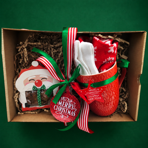 Red Christmas mug gift set in a ribboned gift box on an emerald green background