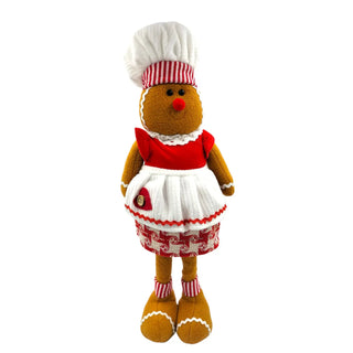 Gingerbread man plush toy wearing a chef's hat and outfit on a white background