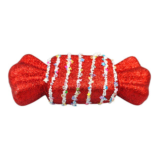 Red glittery candy-shaped ornament with colorful string on a white background for a candyland theme