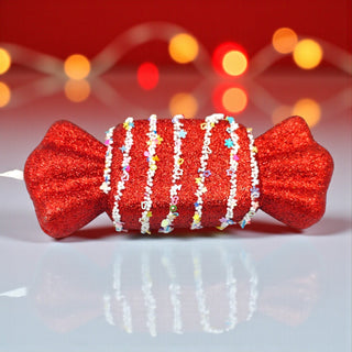 Confetti nougat candy ornament on frosted pine tree with warm fairy lights. red Candyland Christmas decorating inspiration