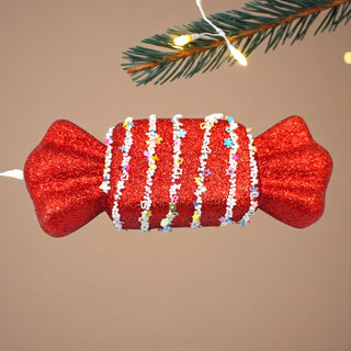 Whimsical Candyland Christmas styling featuring a red nougat candy bauble, warm lights, and playful festive decorations.