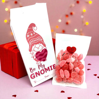 Gnome-themed Valentine's Day card with candy on a pink background