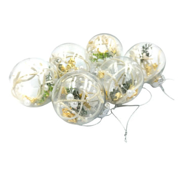 Clear balloons with gold confetti and greenery on a white background