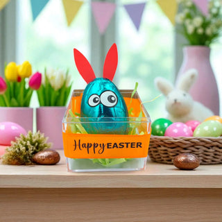 Easter-themed decoration with a blue egg in a clear box, rabbit ears, and 'Happy Easter' banner.