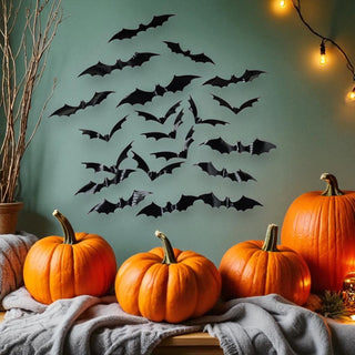 Halloween decorations with pumpkins and bats on a teal wall.