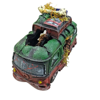 Decorative aquarium scene with a green and red vehicle, plants, and small objects on a white background