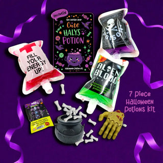 Halloween-themed dice kit with potion packages, a cauldron, and skeleton hand on a purple background.