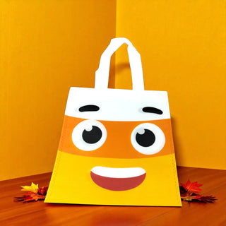 Cartoonish tote bag with a face design on an orange background