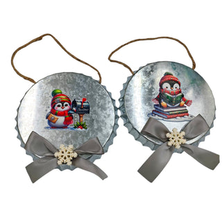 Two Christmas-themed bottle cap ornaments with penguins and snowflakes on a white background.