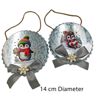 Two Christmas ornaments with penguins and ribbons on a white background