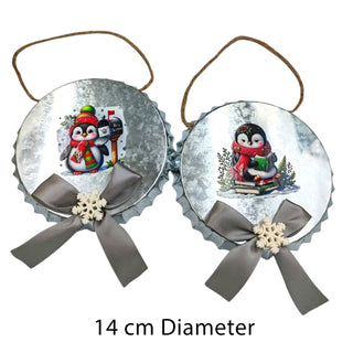 Two Christmas ornaments with penguin designs on a white background 
