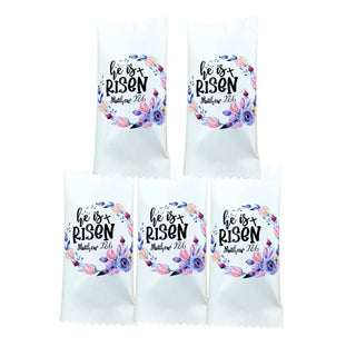 Five white bags with 'He is Risen' text and floral design on a white background