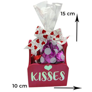 Pink container with chocolates and the word kiss