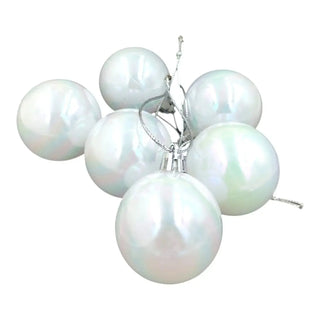 Set of six pearl-like ornaments on a white background