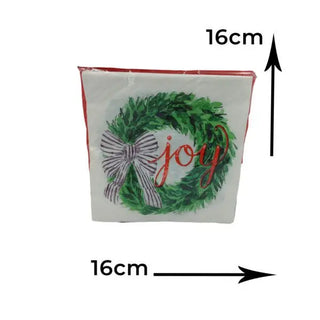white serviette with green wreath adorned with a black-and-white bow and the word "joy"