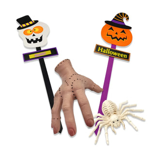 Halloween-themed props including a hand, spider, and pumpkin with a hat on a white background.