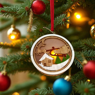 Decorative Christmas ornament with a wooden design of a cabin and trees on a Christmas tree.