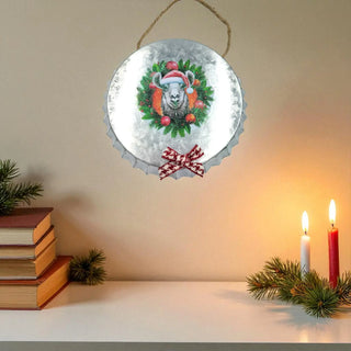 Decorative wall hanging with a festive design of a goat in a wreath, surrounded by candles and books on a shelf.