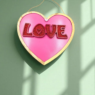 Heart-shaped decoration with 'LOVE' text on a green background