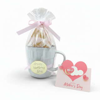 Mug with a gift bag and 'Happy Mother's Day' card on a white background