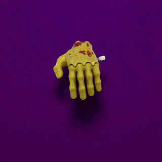 Yellow zombie hand with bloodstains on a purple background