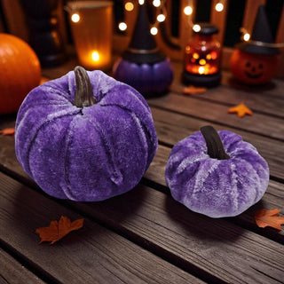 Purple velvet pumpkins on a wooden surface with Halloween decorations in the background.