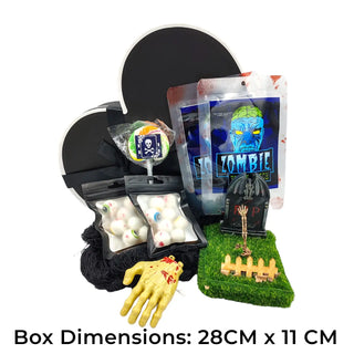 Halloween-themed product set with black box, zombie-themed snacks, and a yellow rubber hand on a white background.