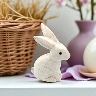 Wooden rabbit figurine on a surface with a blurred background