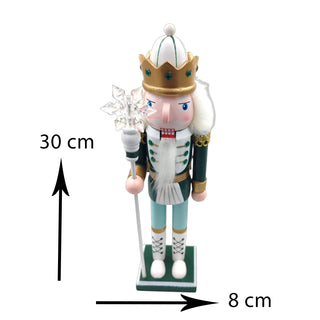 Decorative nutcracker figure with a crown and staff on a white background for a sage Christmas aesthetic