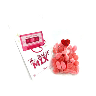 Cassette tape-shaped card with 'I Love You' message and a bag of heart-shaped gummy bears on a white background.