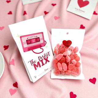 Cassette tape-shaped card with 'The Perfect Mix' text and heart-shaped candy on a pink background with hearts.