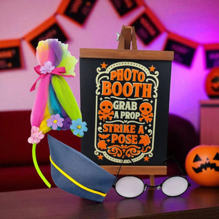 Photo booth sign with props on a table against a Halloween-themed background