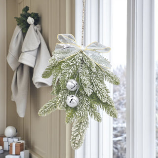 Decorative hanging plant with silver bells in a home setting