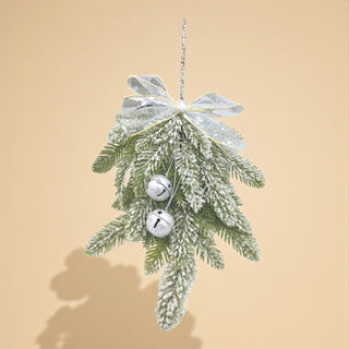 Decorative Christmas ornament with greenery, silver bells, and a bow on a beige background