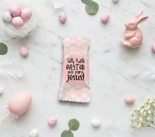 Pink Easter candy bar with text on a marble surface with Easter decorations.