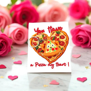 Card with pizza design and 'You have a pizza my heart!' text, surrounded by pink roses and heart-shaped candies.