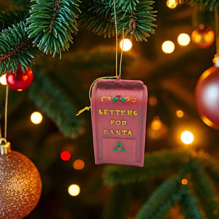 Decorative ornament shaped like a mailbox with 'Letters for Santa' text, hanging on a Christmas tree.