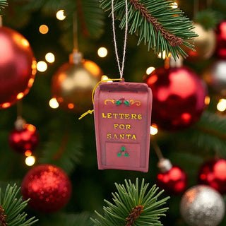 Decorative mailbox ornament labeled 'Letters for Santa' hanging on a Christmas tree with ornaments and lights.