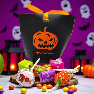 Halloween-themed gift bag with candy on a festive background