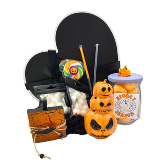 black heart shaped box. orange ceramic pumpkin stack, wooden pumpkin, lollipop, 2 candy eye packets, 2 halloween themed candy straws and a Halloween themed jar filled with candy