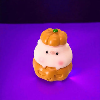 Cute character figurine with a pumpkin on a purple background